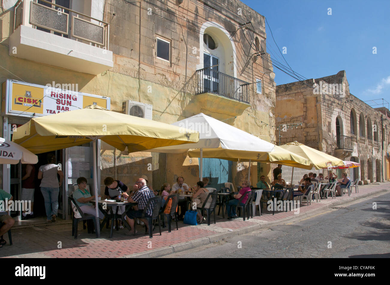 People enjoying lunch at outdoors restaurant Marsaxlokk Malta Stock