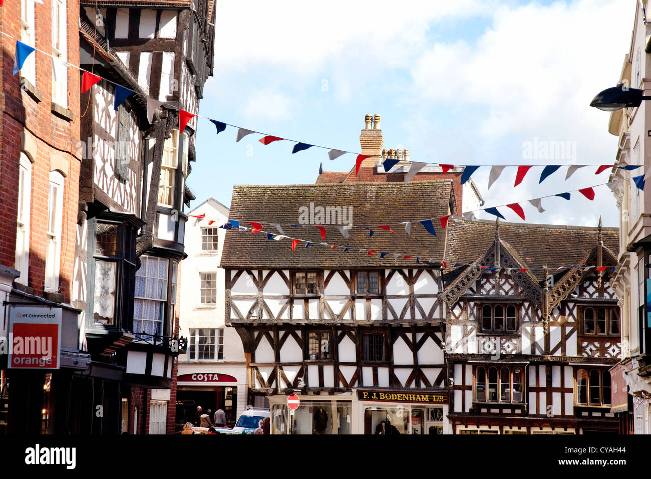 UK medieval town; Medieval 16th century half timbered buildings and bunting, Ludlow town centre, Shropshire England UK Stock Photo