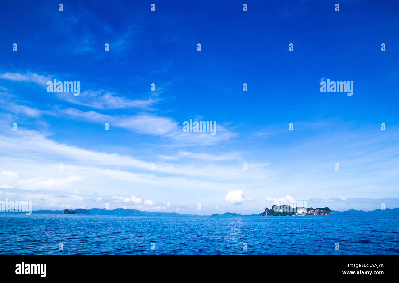 cloudy blue sky above a surface of the sea Stock Photo