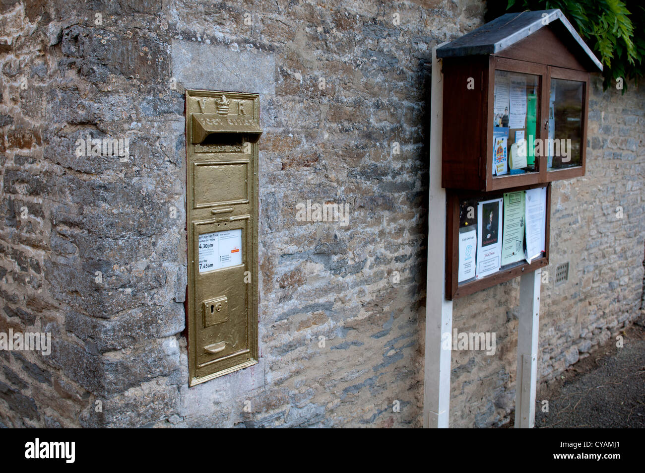 Gold postbox, Ampney St. Peter, Gloucestershire. UK Stock Photo