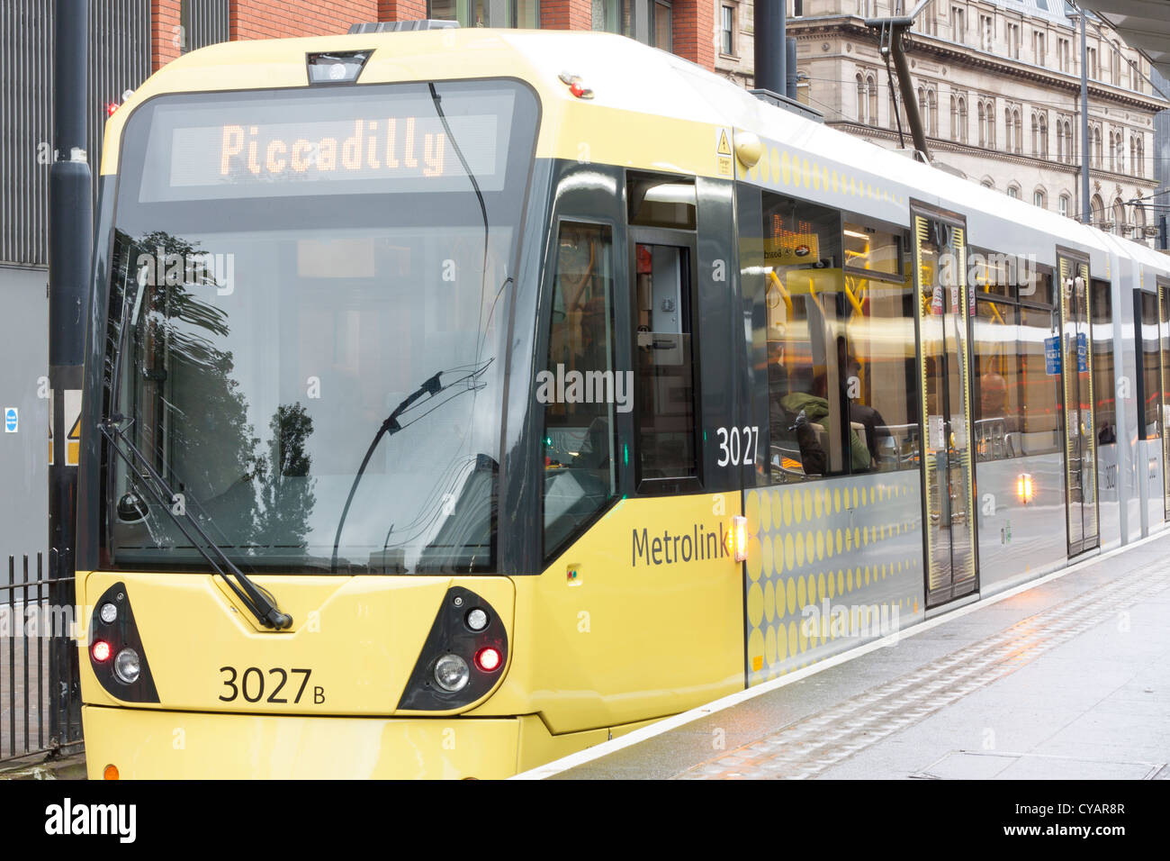 Piccadilly Tram Station, Manchester. Iconic yellow city tram pulls into