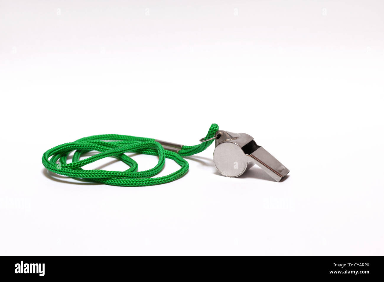 Pea whistle with a green string on white background Stock Photo