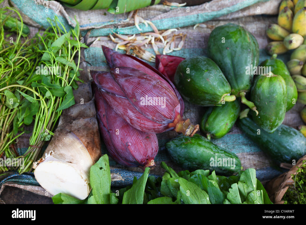 Banana flowers and green papaya on asian food market Stock Photo Alamy