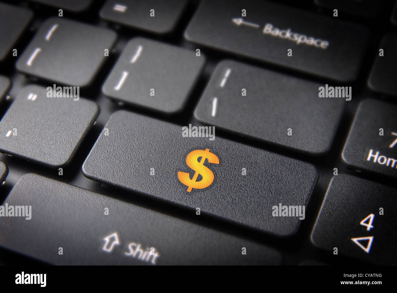 Make money with internet: yellow dollar currency symbol on laptop keyboard. Included clipping path, so you can easily edit it. Stock Photo