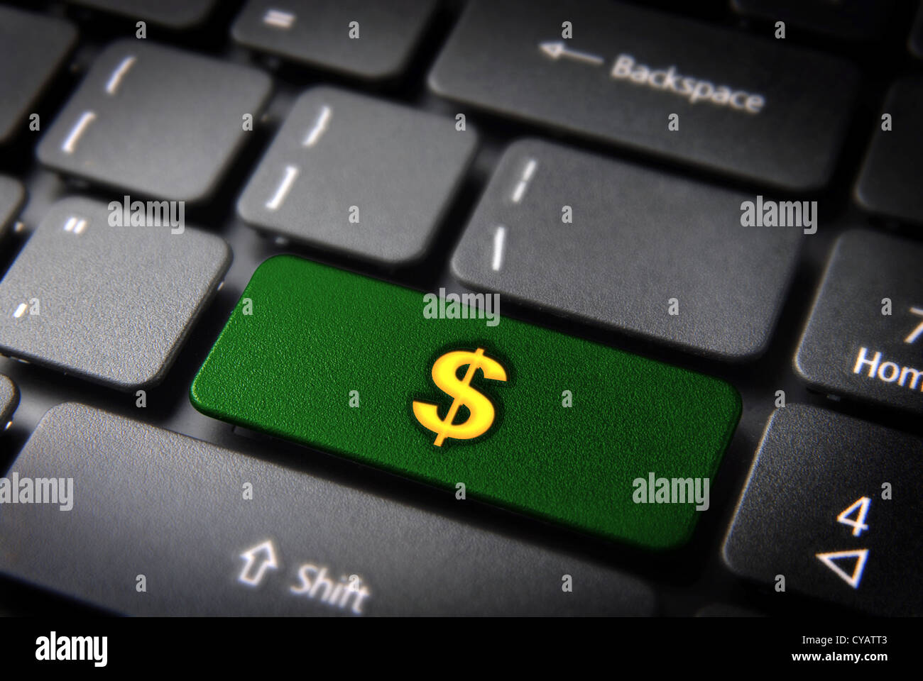 Make money with internet: green key with dollar  icon on laptop keyboard. Included clipping path, so you can easily edit it Stock Photo