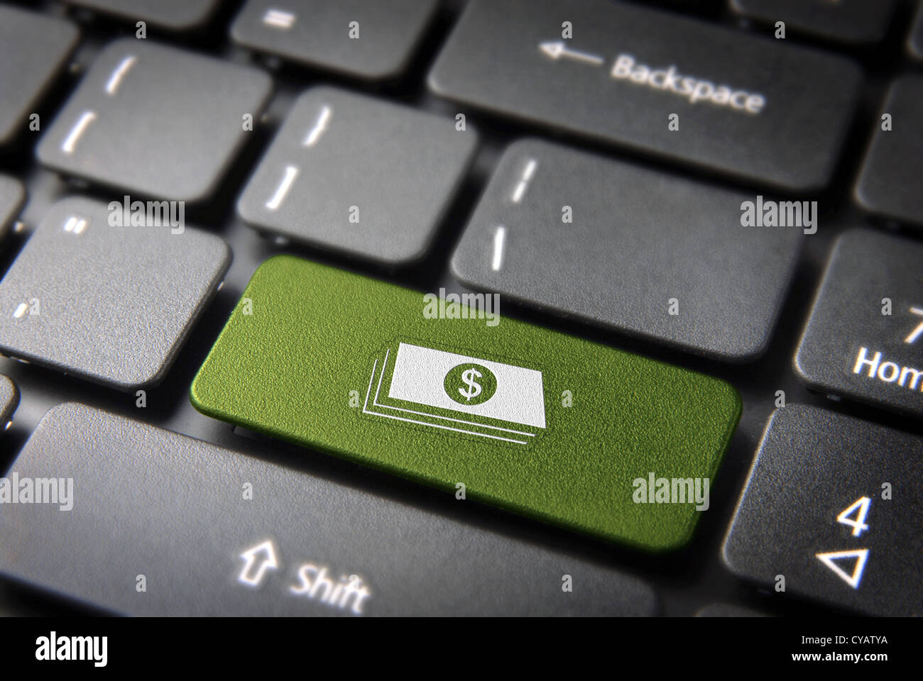 Make money with internet: green key with dollar bills icon on laptop keyboard. Included clipping path, so you can easily edit it. Stock Photo