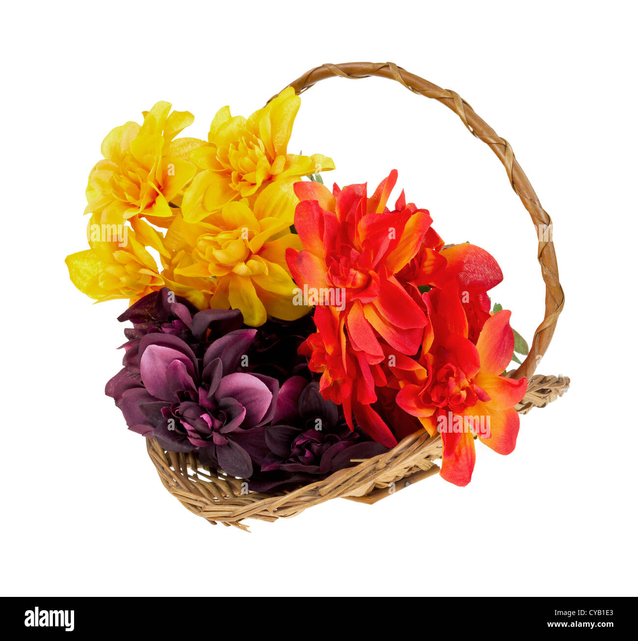 A small wicker basket filled with colorful artificial flowers on a white background. Stock Photo