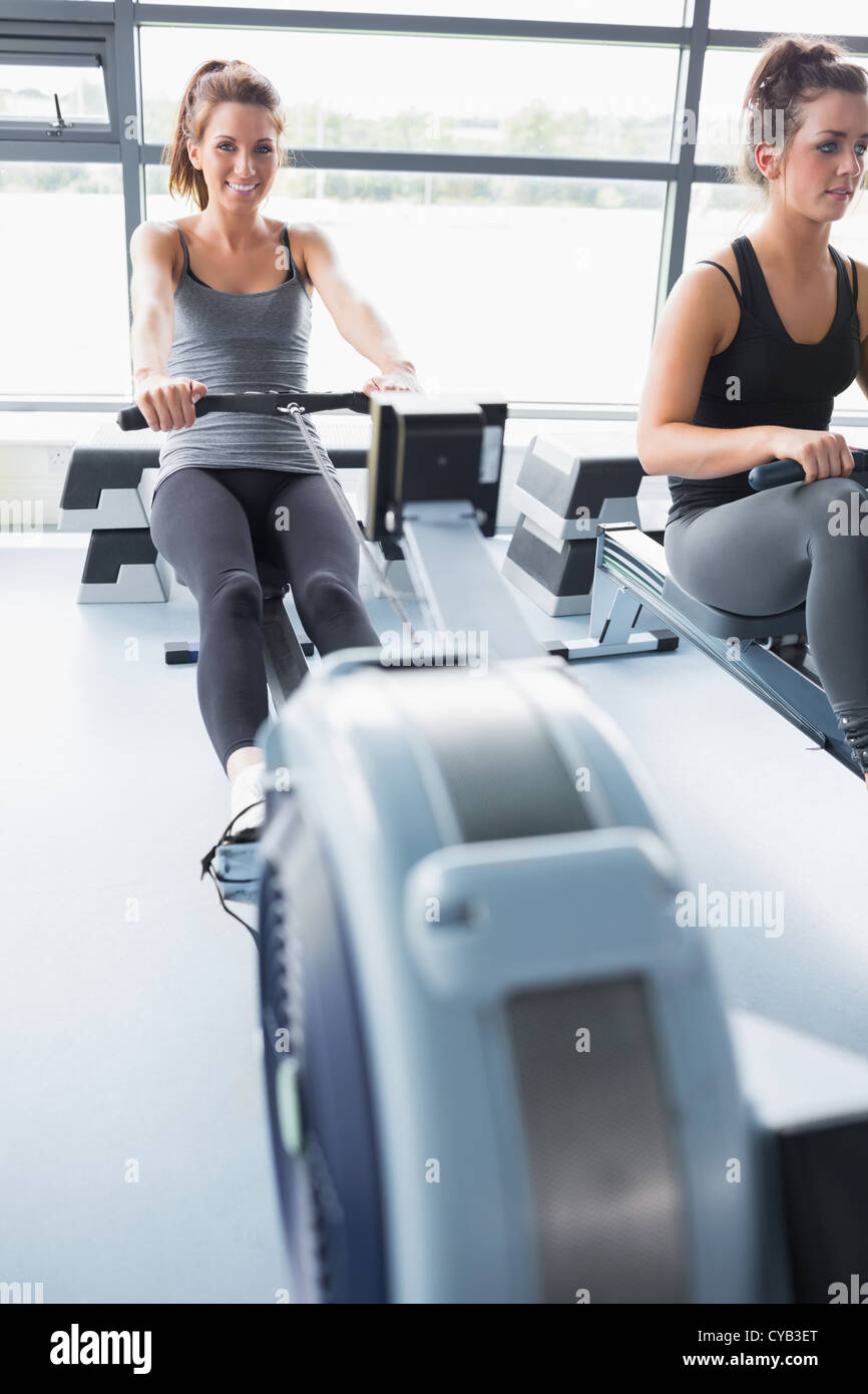 Two people training on row machines Stock Photo - Alamy