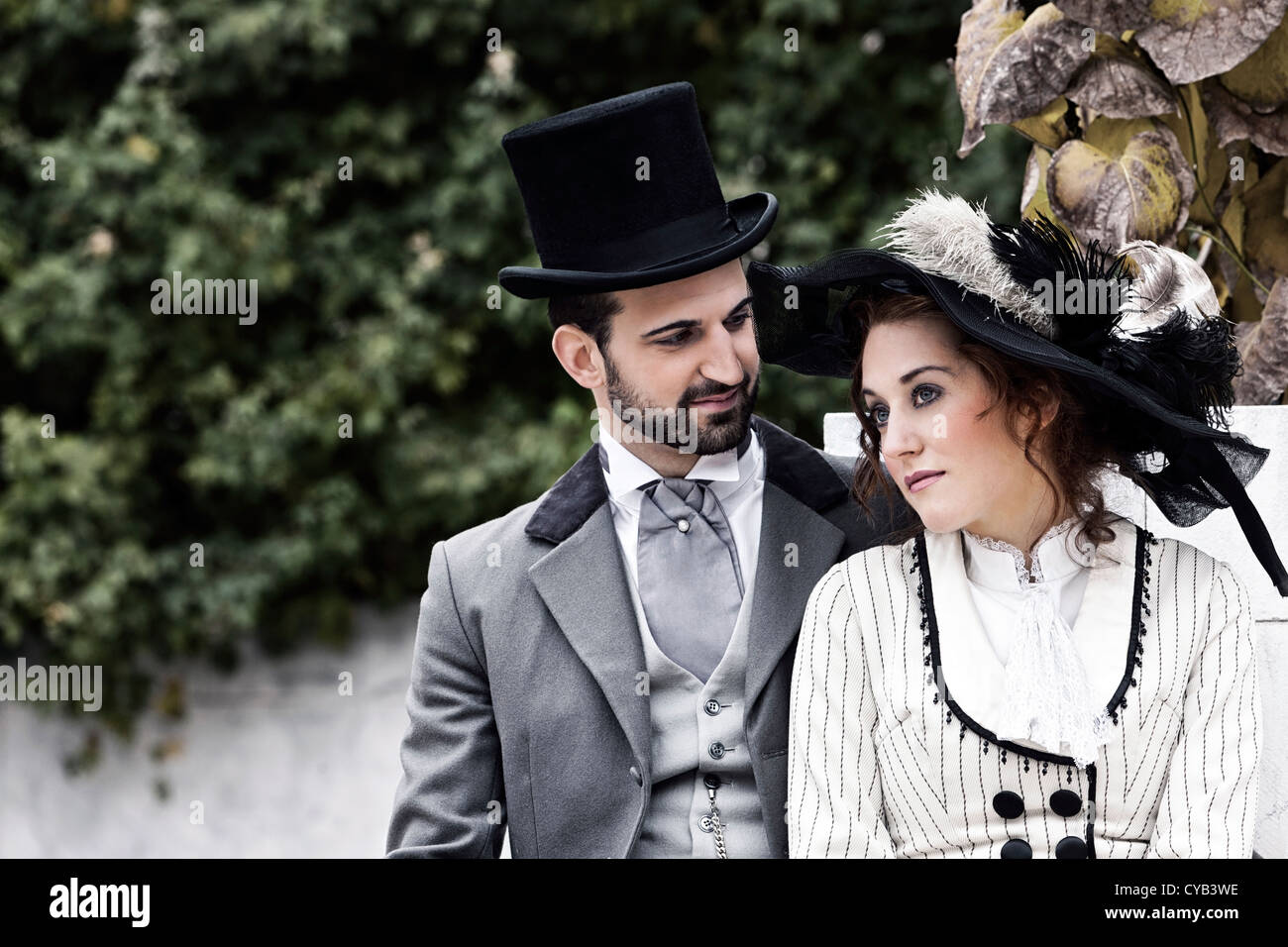 Old-fashioned dressed couple in the park Stock Photo