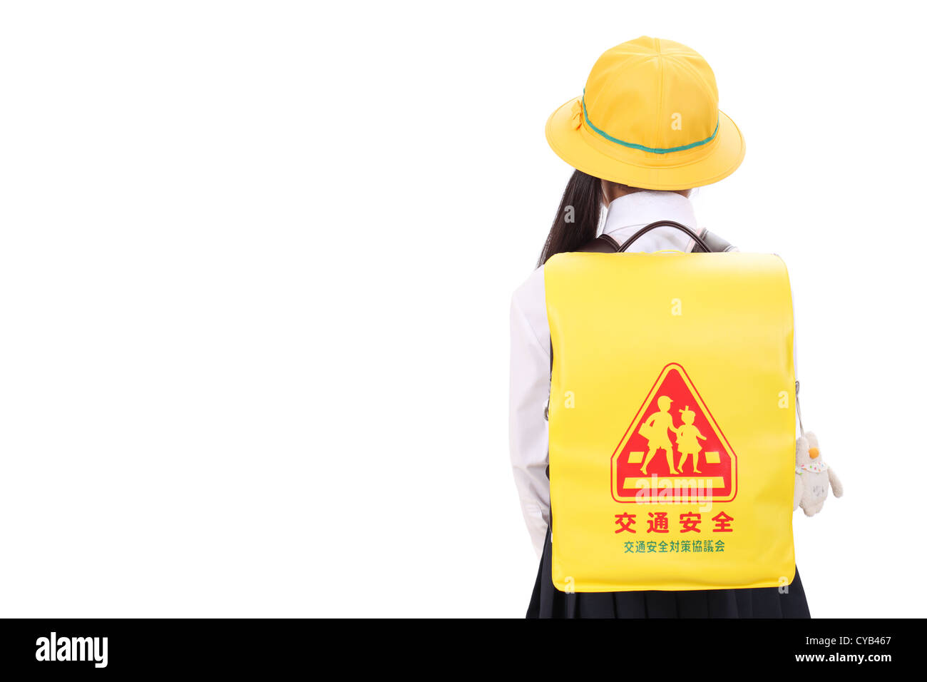 Rear view of little asian schoolgirl standing with schoolbag Stock Photo