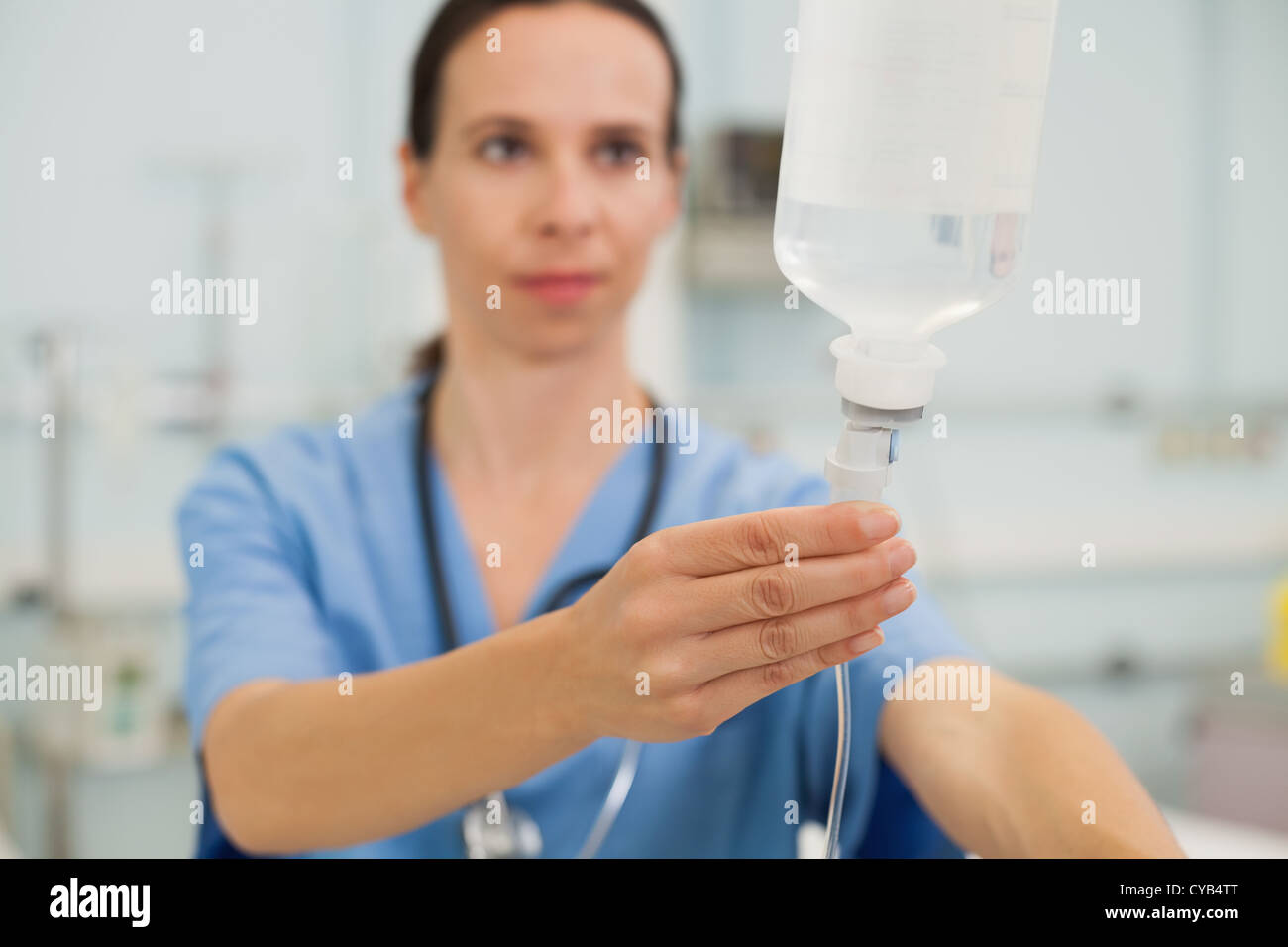 Nurse adjusting drip Stock Photo