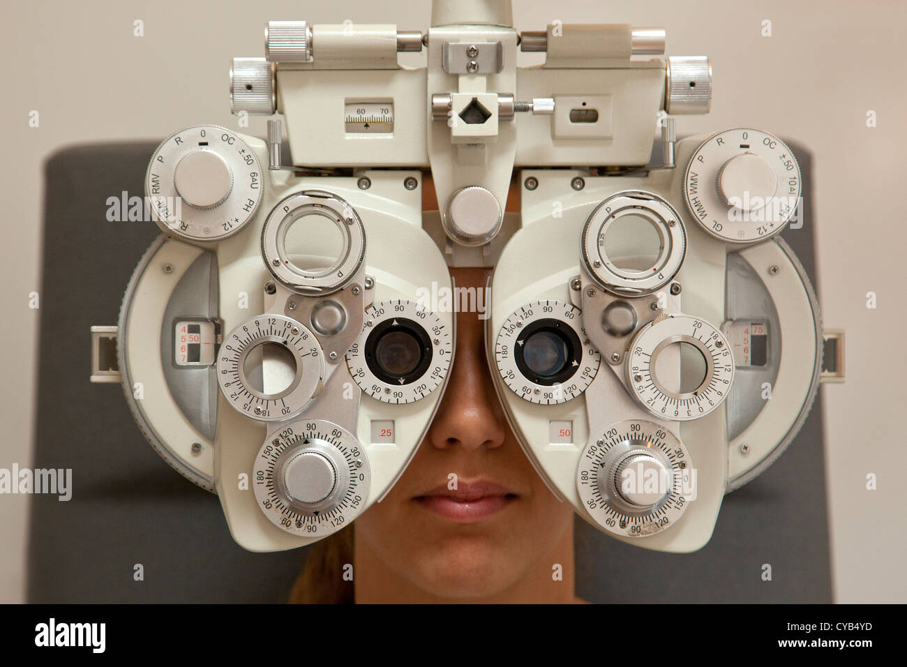 woman patient having an eye test examination on a Reichert ultramatic phoropter, autorefractometer instrument in eye clinic. Stock Photo