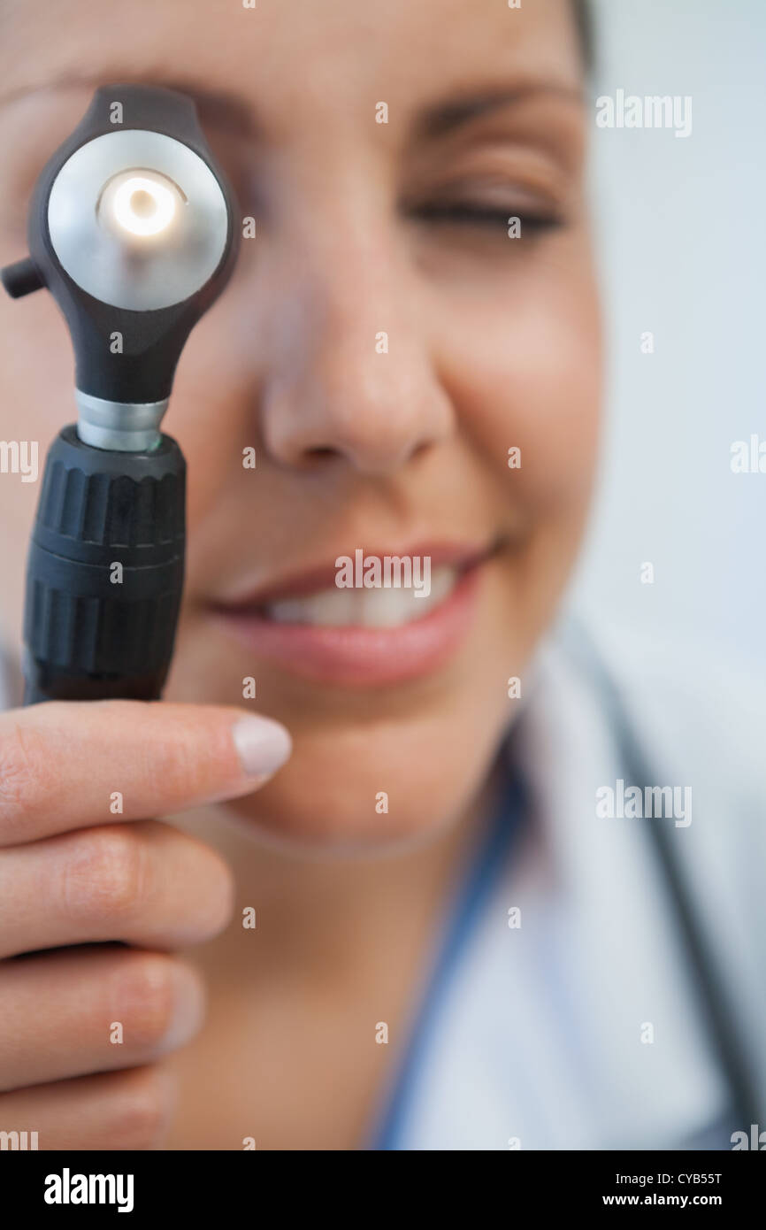 Nurse using otoscope Stock Photo Alamy