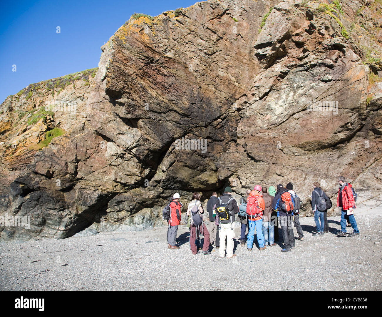 Lizard Point Rocks Geologists study rocks in cliffs at Lizard Point, Cornwall, England ...