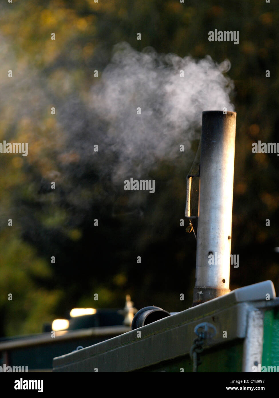 Smoking chimney on a canal boat, UK Stock Photo