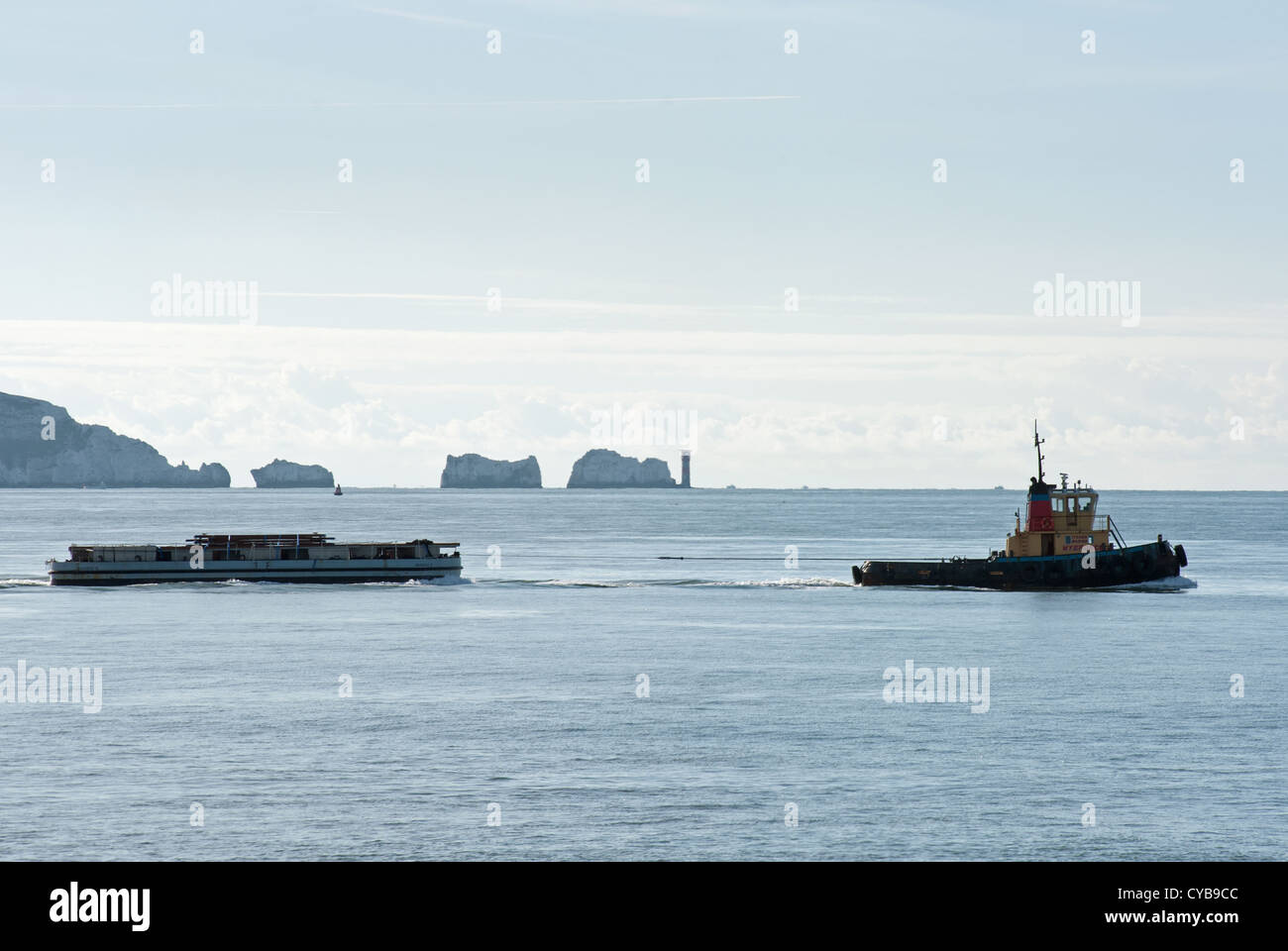 tugboat towing cargo near the needles Isle of Wight Stock Photo