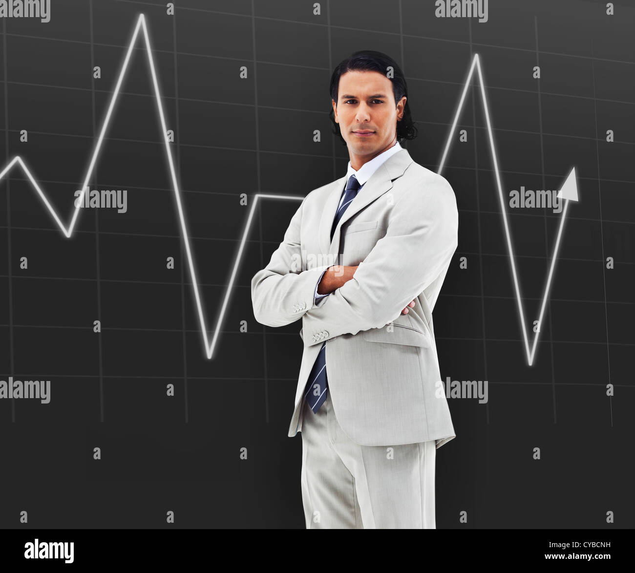 Man with arms crossed standing in front of a statistic Stock Photo