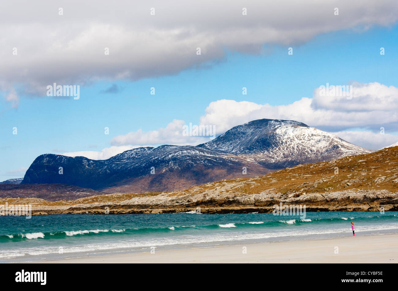 A young girl leans into the breeze at Luskentyre beach on the Isle of Harris, Scotland Stock Photo