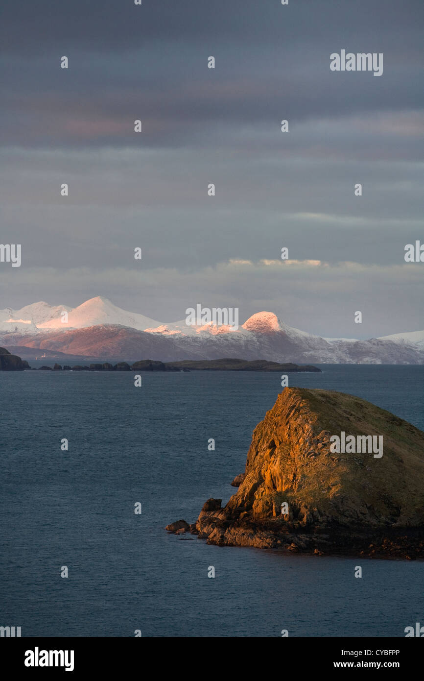 A view to snow covered mountains on the Isle of Harris seen from Duntulm, Trotternish, Isle of Skye, Hebrides, Scotland, United Kingdom Stock Photo