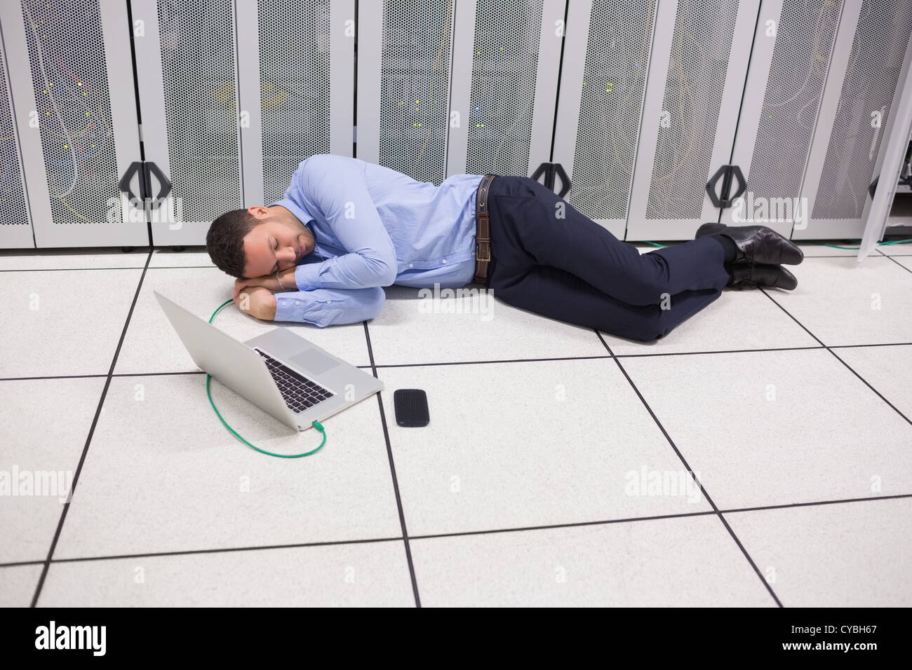Man sleeping in data center Stock Photo