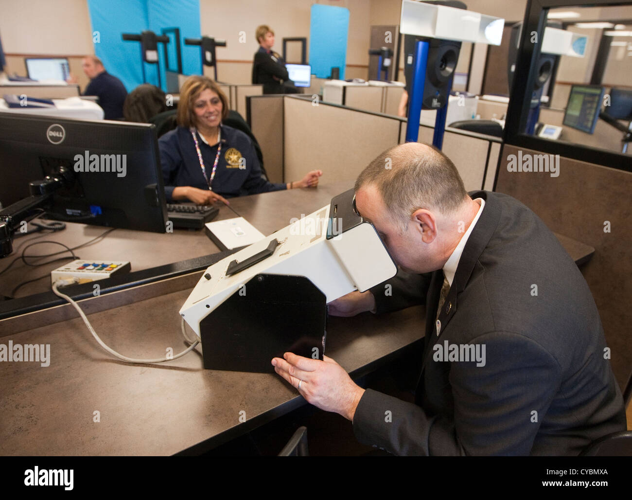 Customer in to renew driver's license gets finger-printed and completes eye exam at the Texas Department of Public Safety Stock Photo