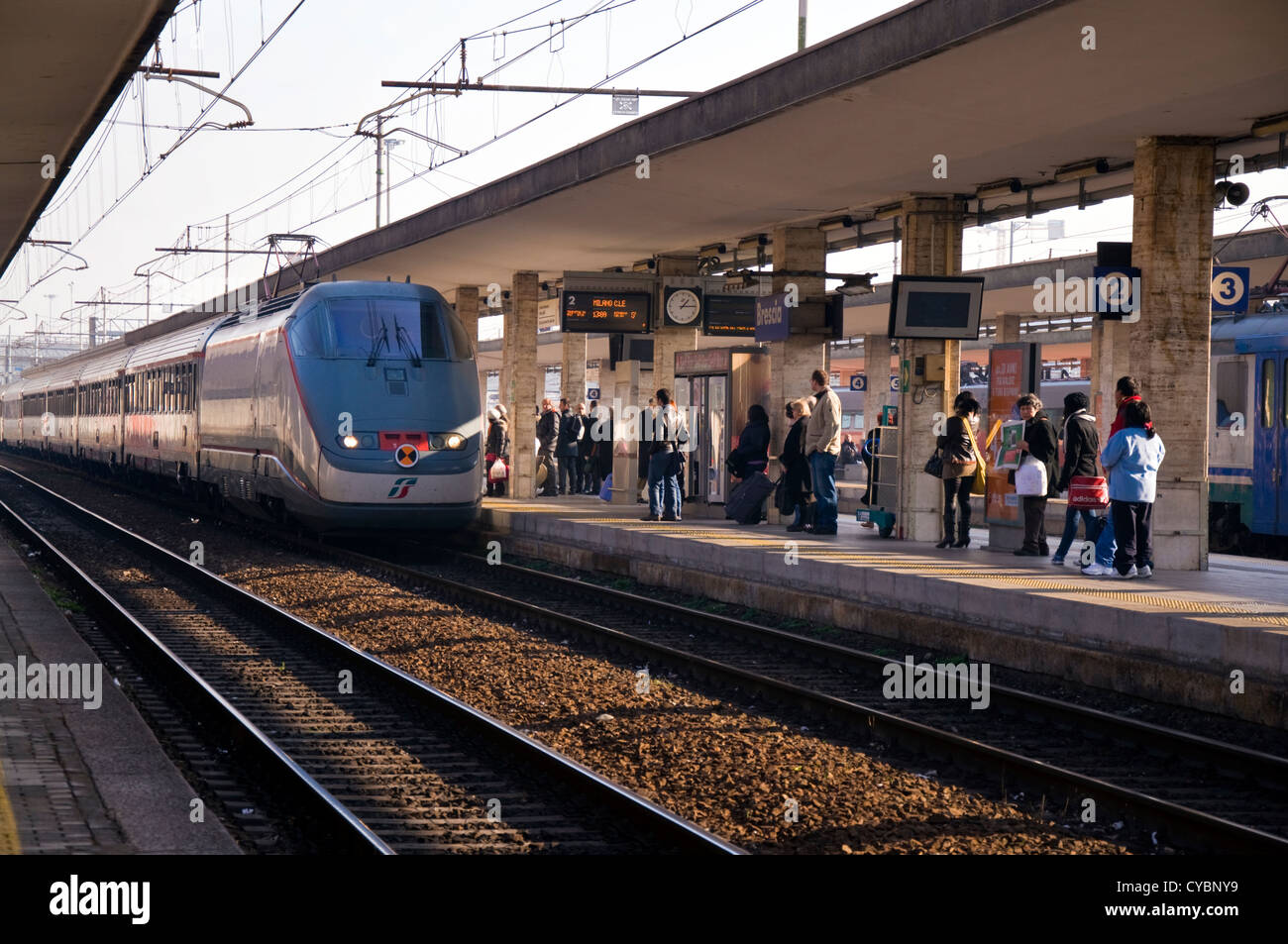 Passengers at Brescia railway station await the arrival of Tenitalia  express to Milan Stock Photo - Alamy, image size:1300x953