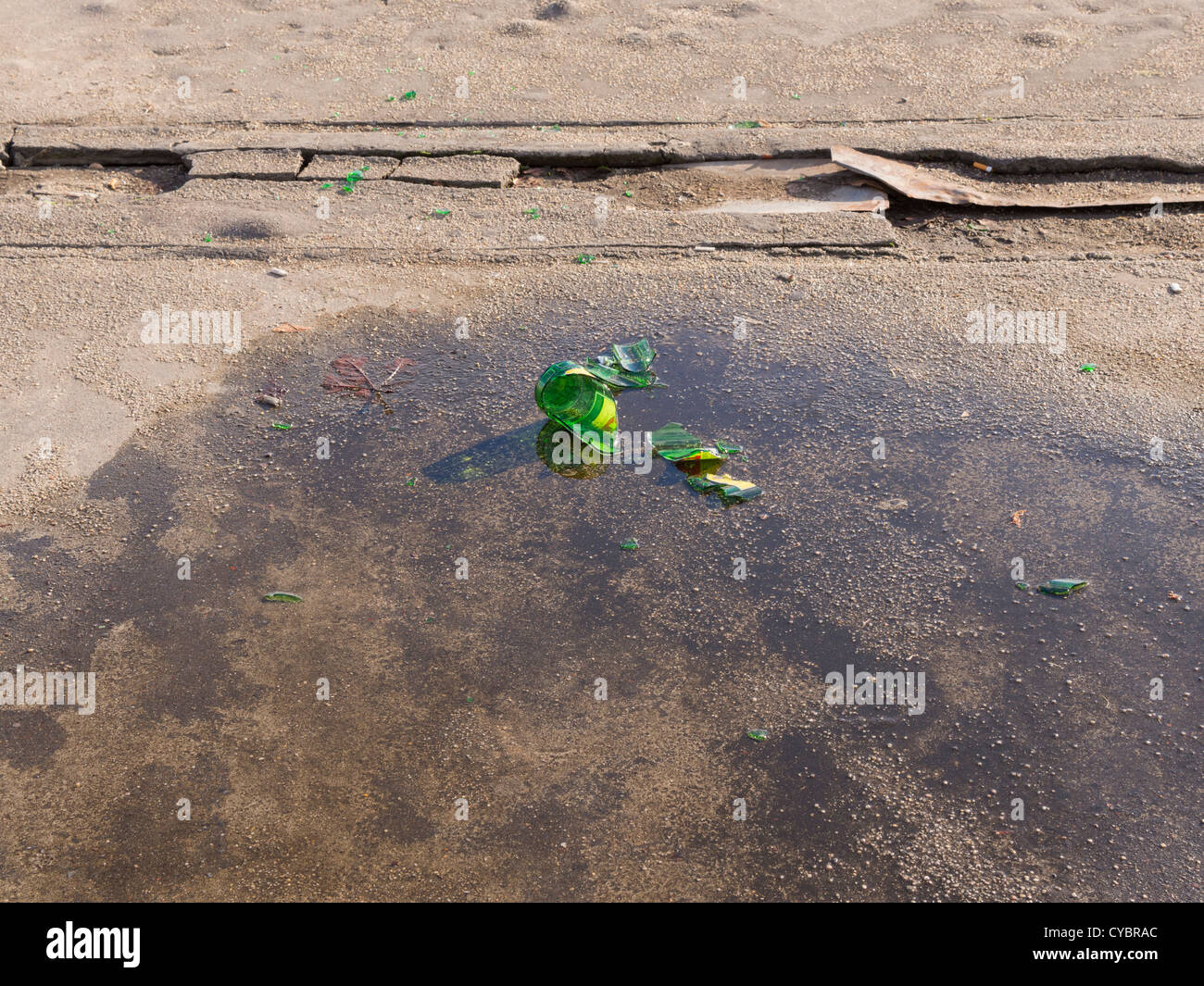 Broken glass bottle on the ground. Stock Photo