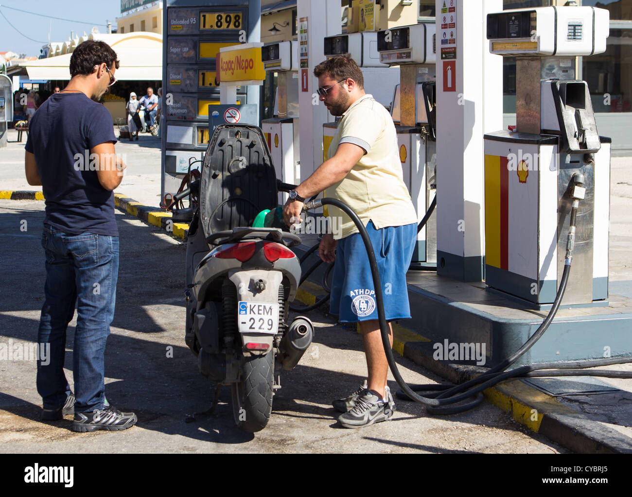 Motorcyclist filling up with petrol at Shell Petrol station Argostoli Cephalonia Greece. Stock Photo