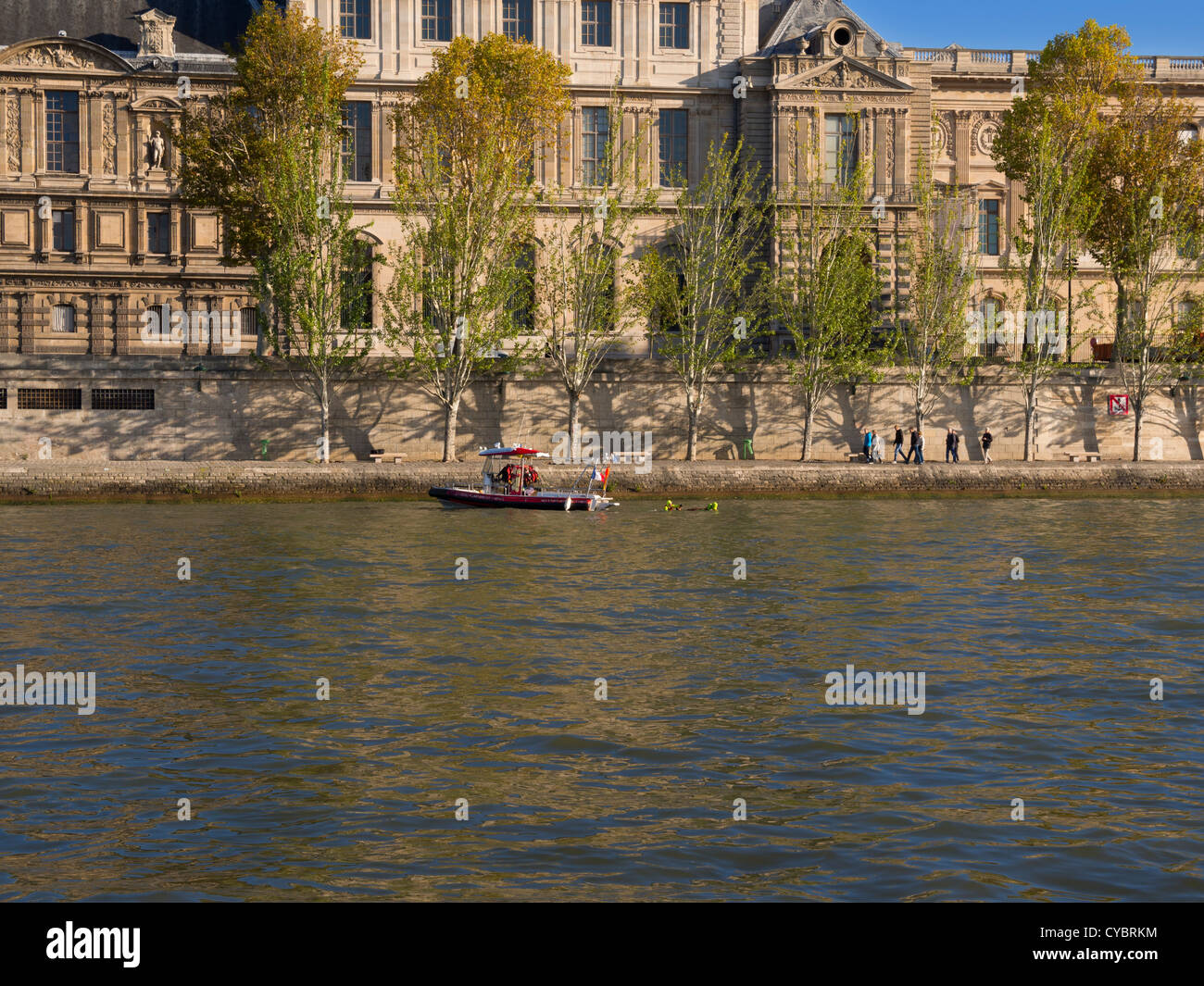 Fire Services rescue boat on the Seine River, Paris. Firemen on a rescue boat practice on the Seine in front of the Louvre. Stock Photo