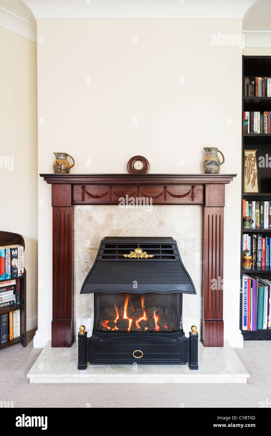 Fireplace and mantelpiece in a typical British home, UK Stock Photo