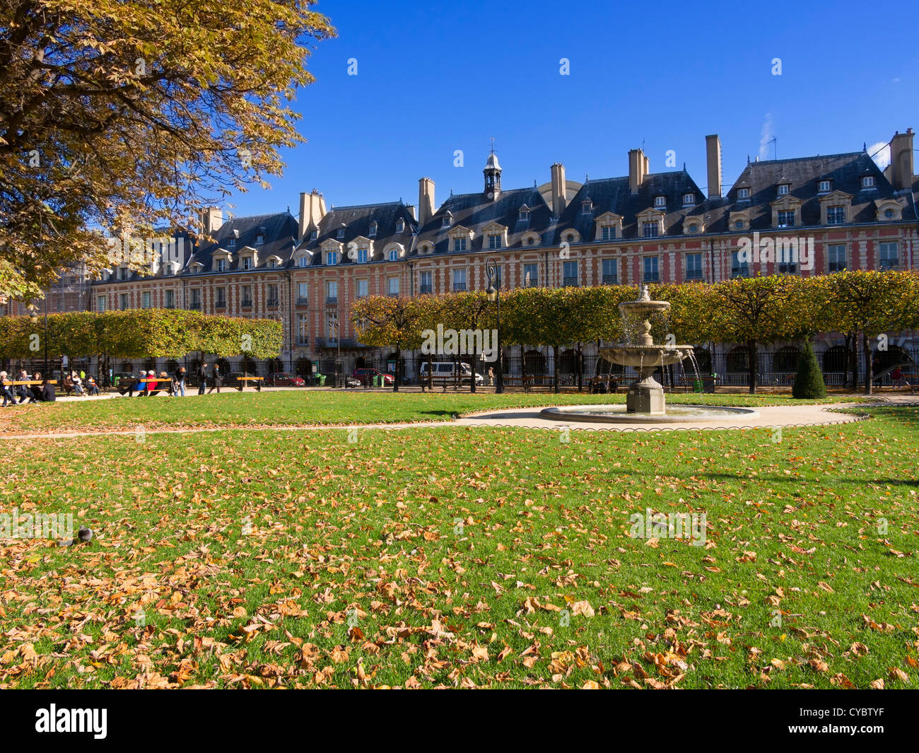 Autumn in Place des Vosges, Paris. This is the oldest planned square in Paris, with uniform houses lining a large central park. Stock Photo