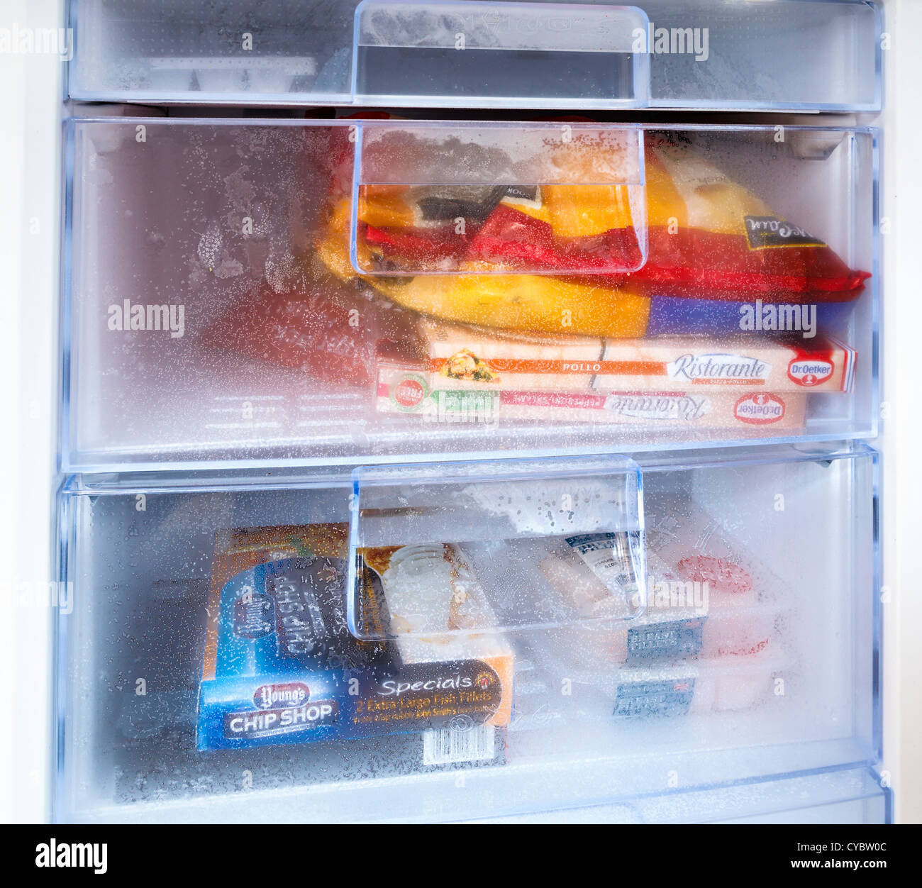 Freezer compartment with frozen food close up Stock Photo