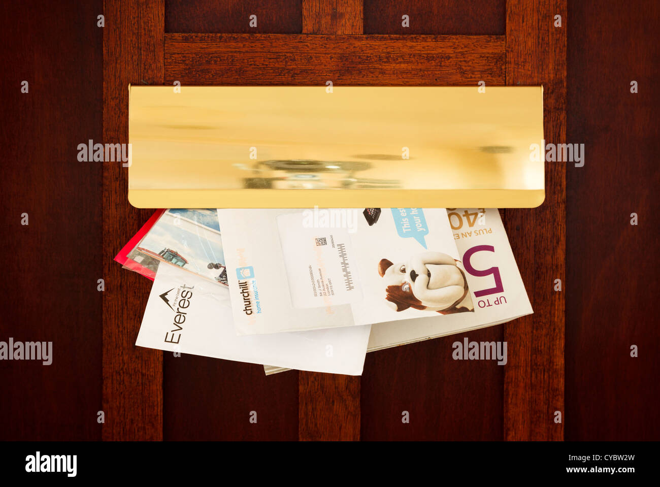 Letters and junk mail coming through a letter box, UK - details changed for security Stock Photo