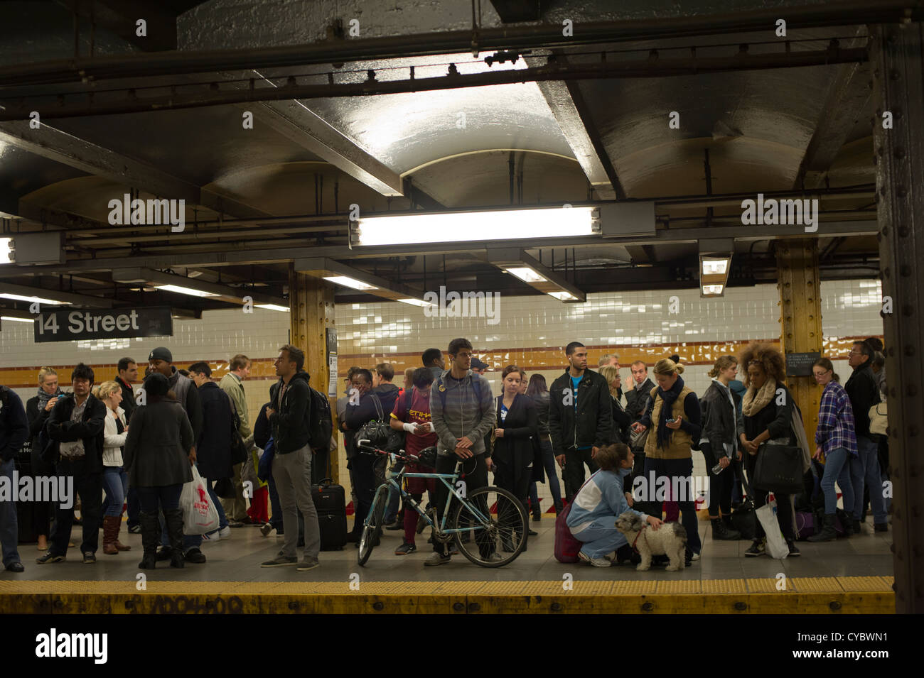 Transit riders are seen waiting for an uptown subway train at the West ...