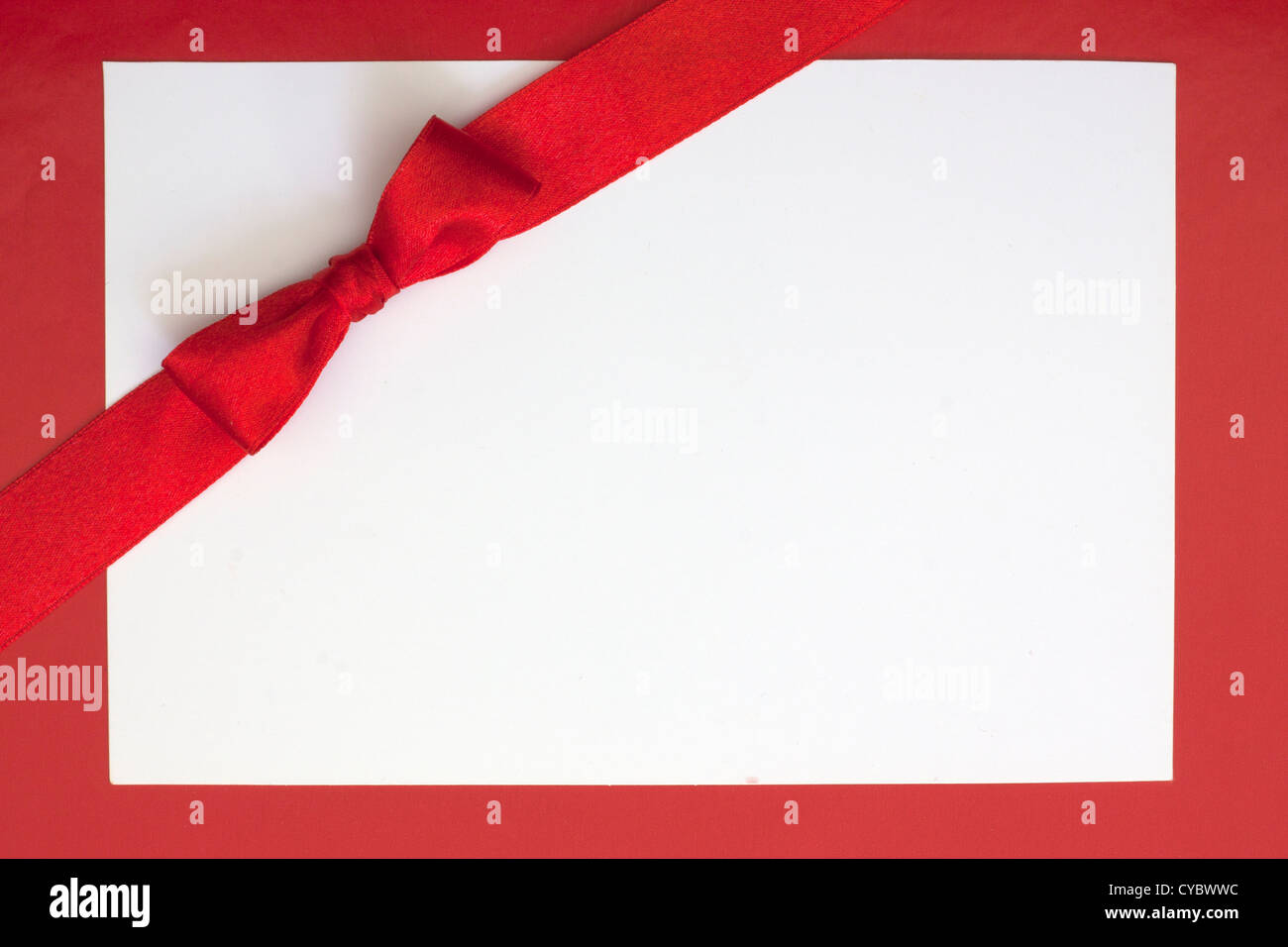 Christmas sheet of paper and red ribbon gift background Stock Photo