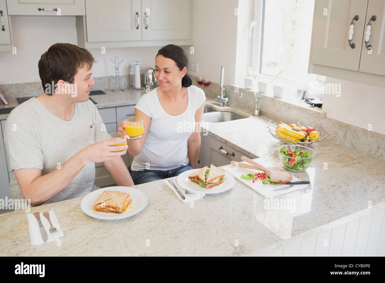 Two people eating and drinking Stock Photo