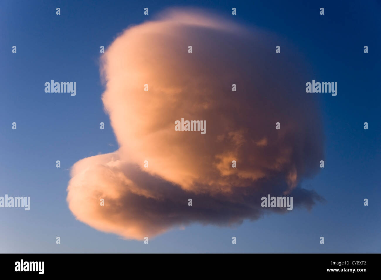 Heart-shaped cloud on sunset sky Stock Photo