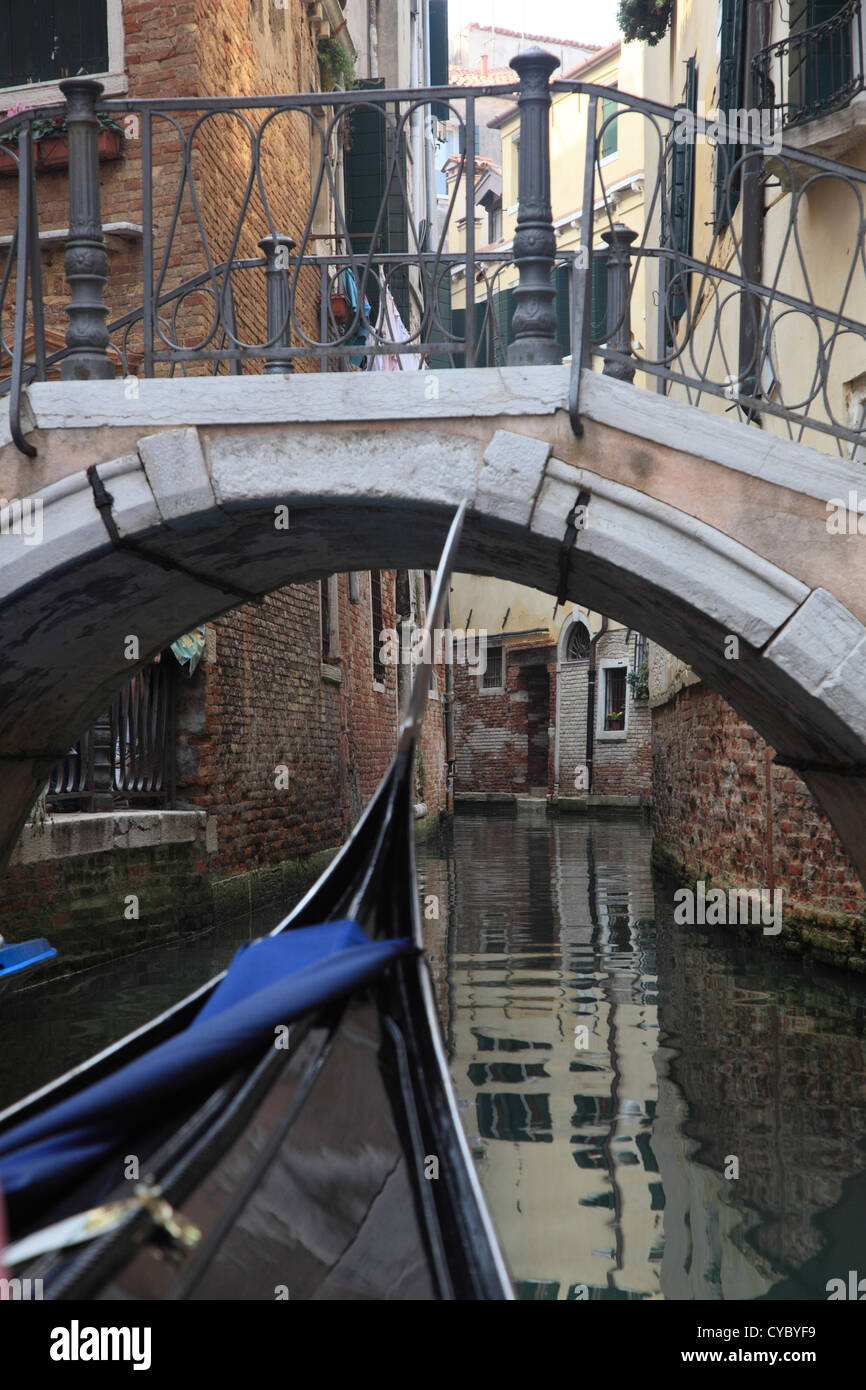 Venice - the Pearl of Italy. Gondola floated under the bridge in Venetian canal Stock Photo