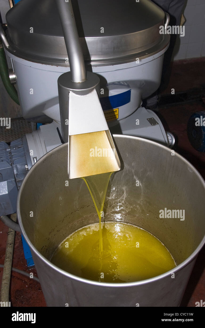 Freshly pressed olive oil leaving the press Stock Photo Alamy
