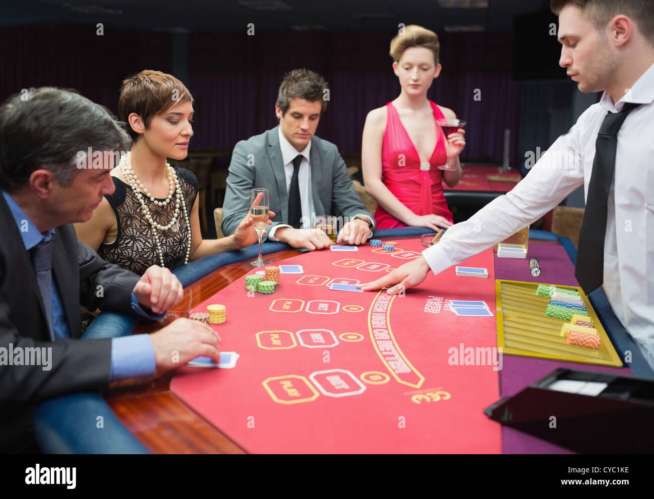 Four people playing poker Stock Photo