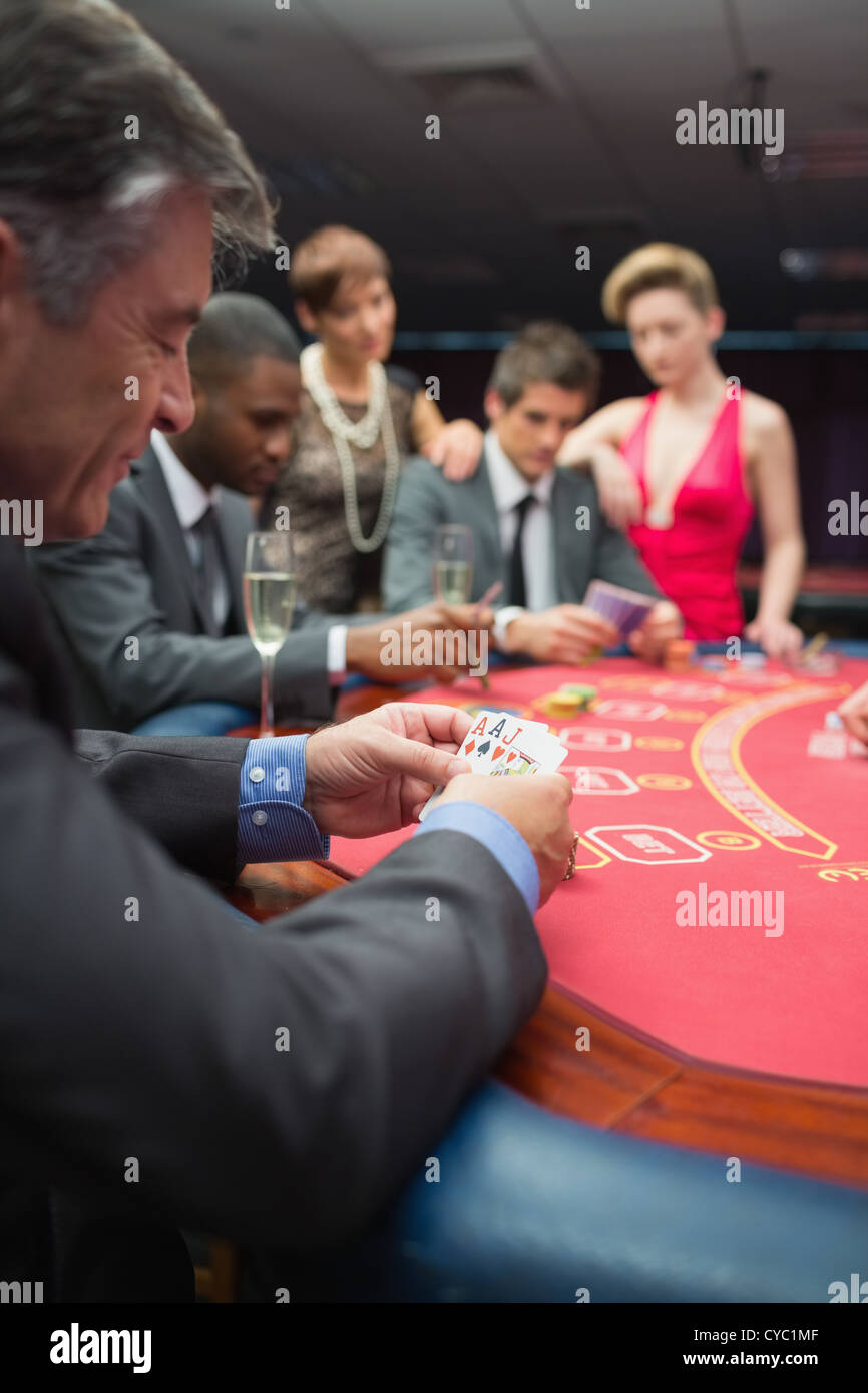 People playing at the poker table Stock Photo