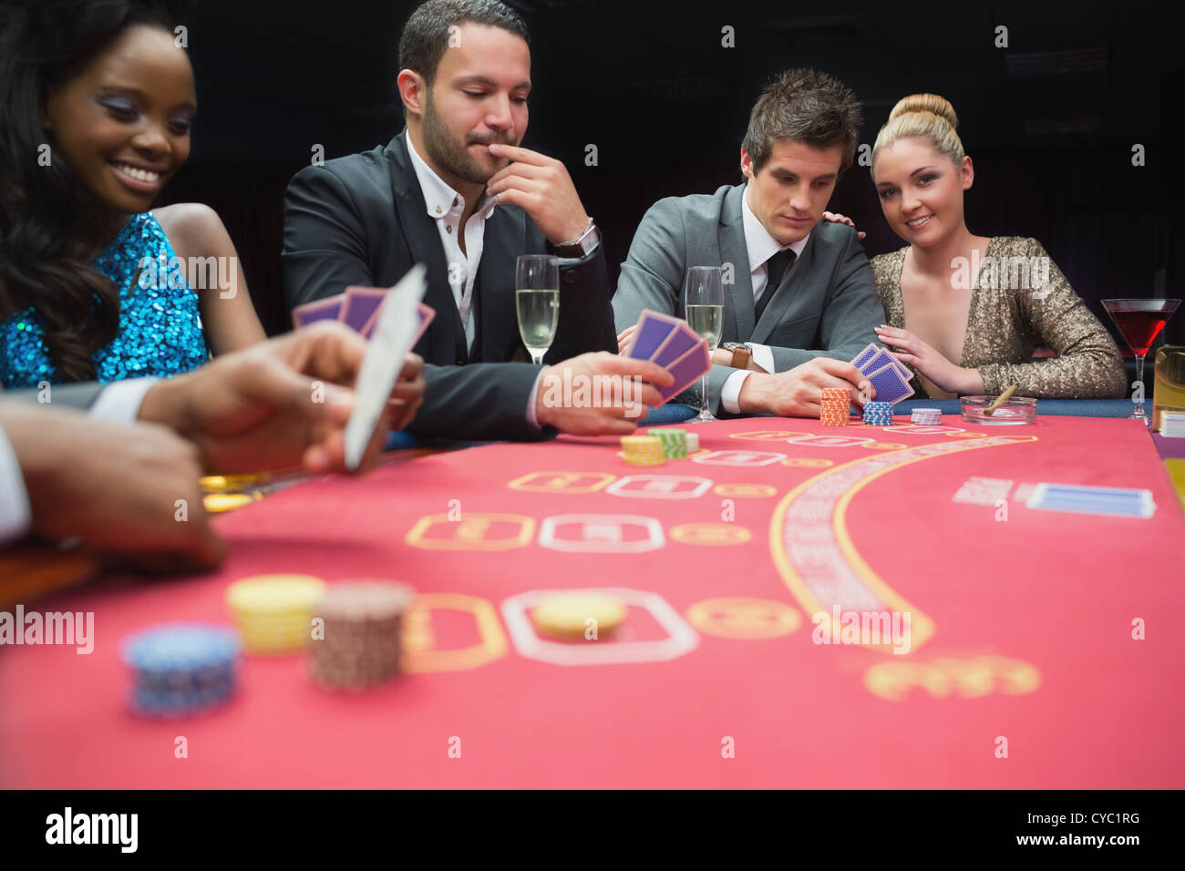 Happy people playing poker Stock Photo