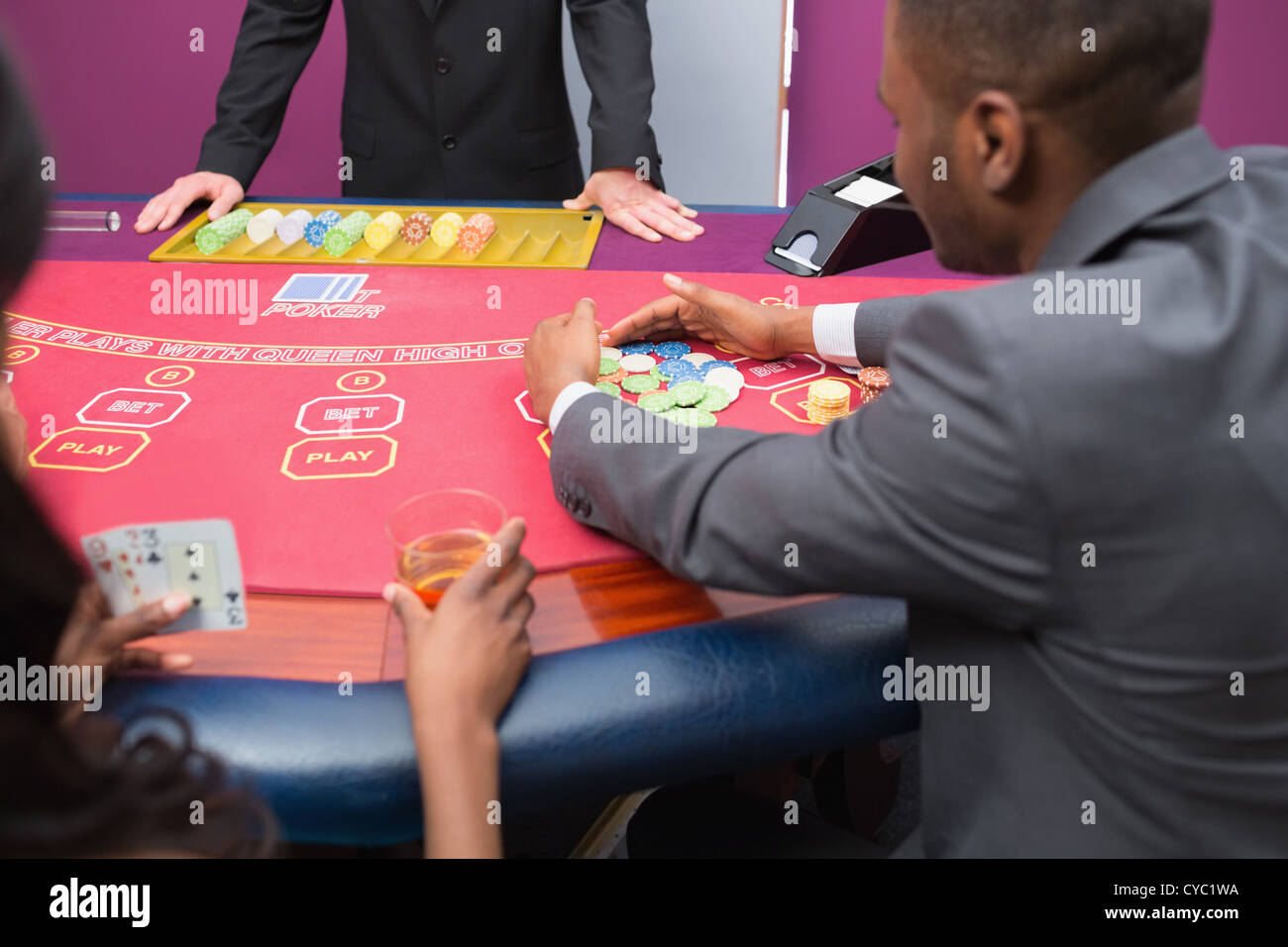 Man grabbing chips at poker table Stock Photo