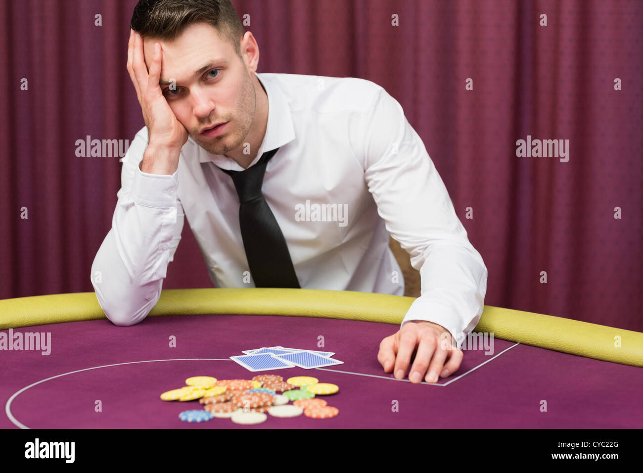 Man looking worried at poker table Stock Photo Alamy