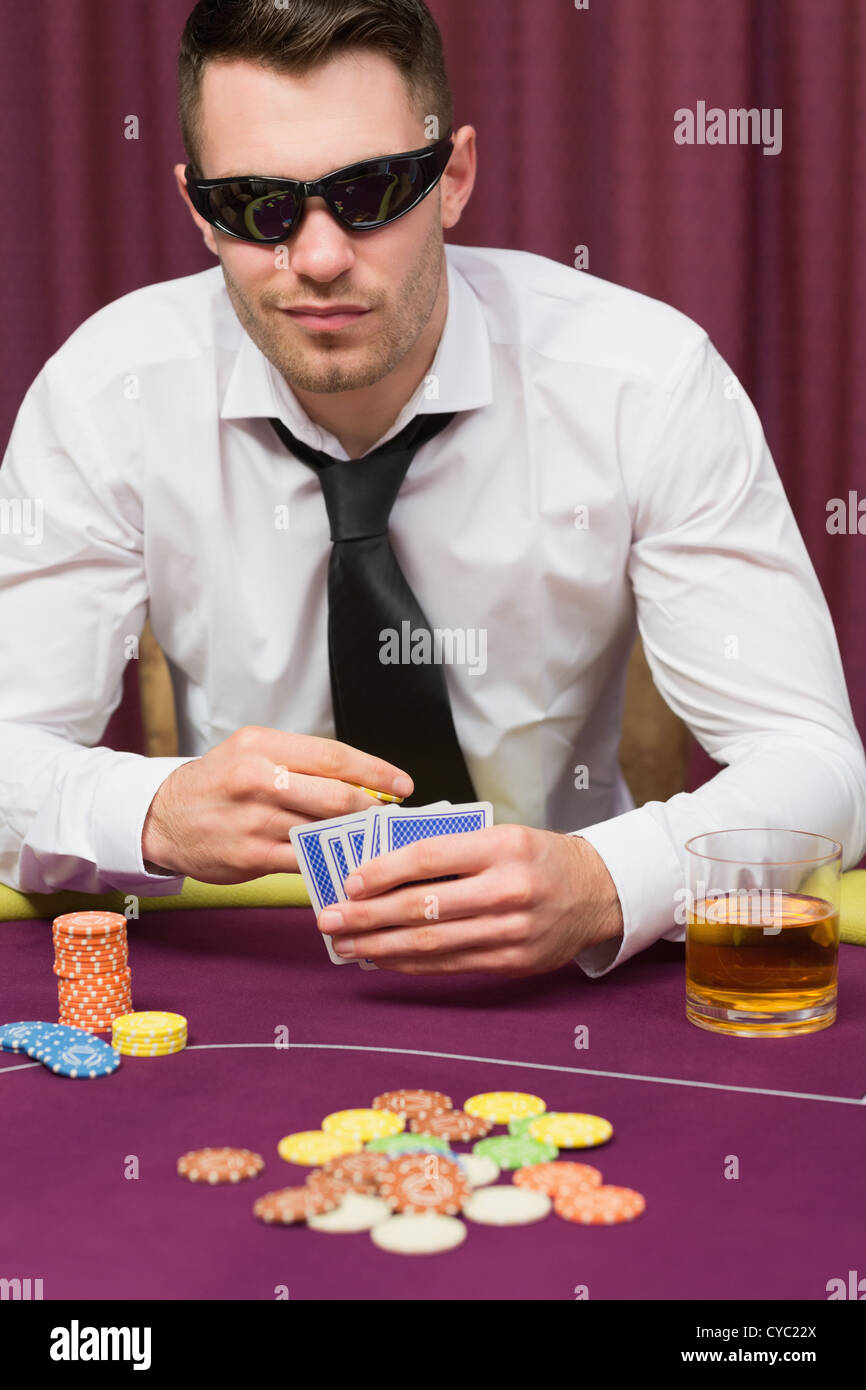 Man in sunglasses playing poker Stock Photo Alamy
