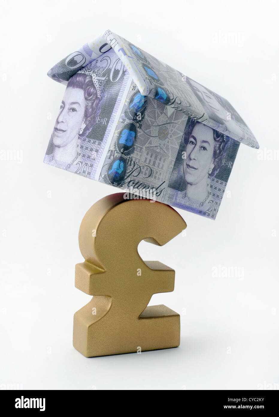 HOUSE MADE OF BRITISH CURRENCY BALANCING ON POUND SIGN RE SAVINGS MORTGAGES INCOMES WAGES THE ECONOMY RECESSION FIRST BUYERS UK Stock Photo