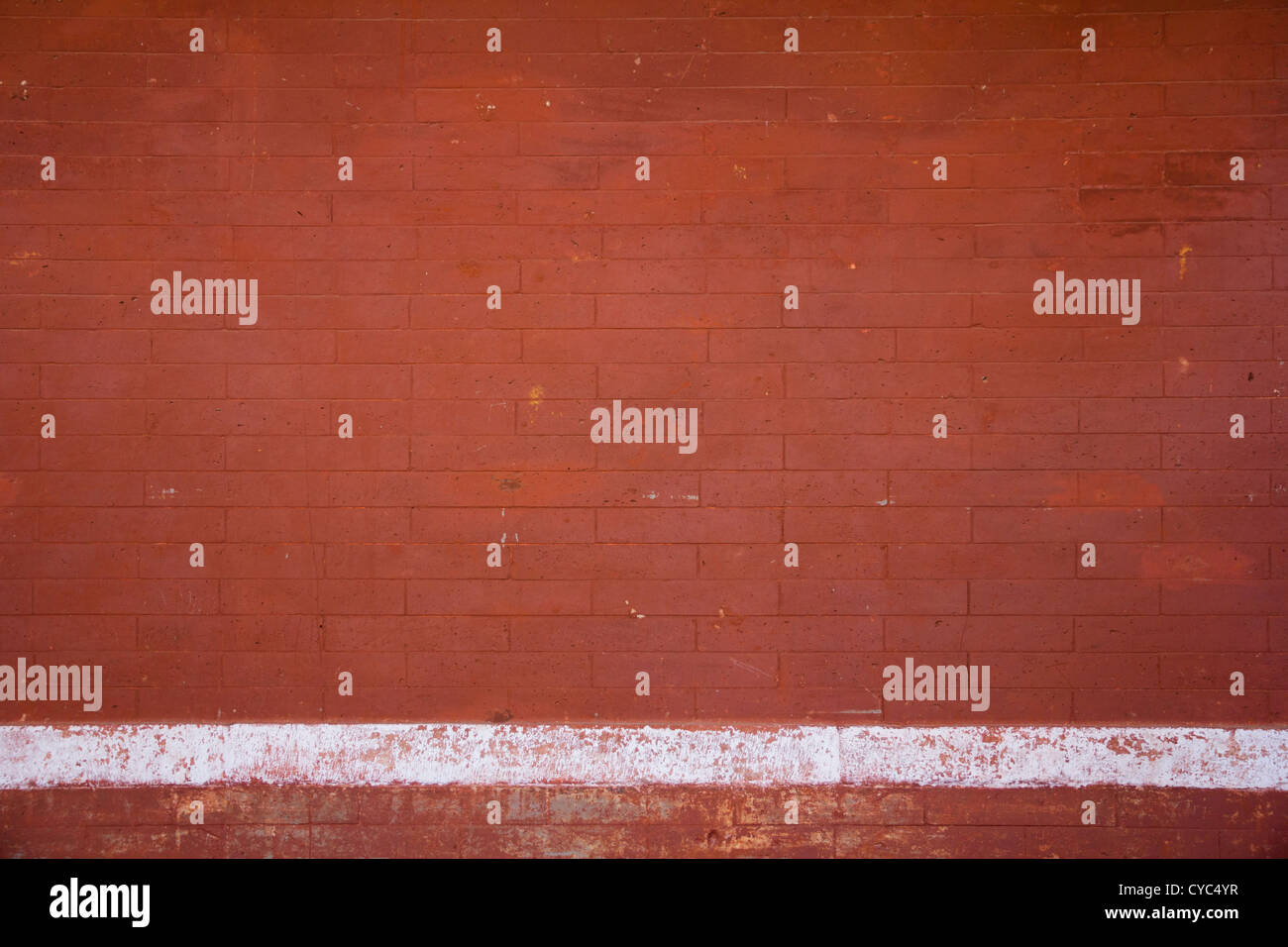 Red brick wall with white chalk line Stock Photo