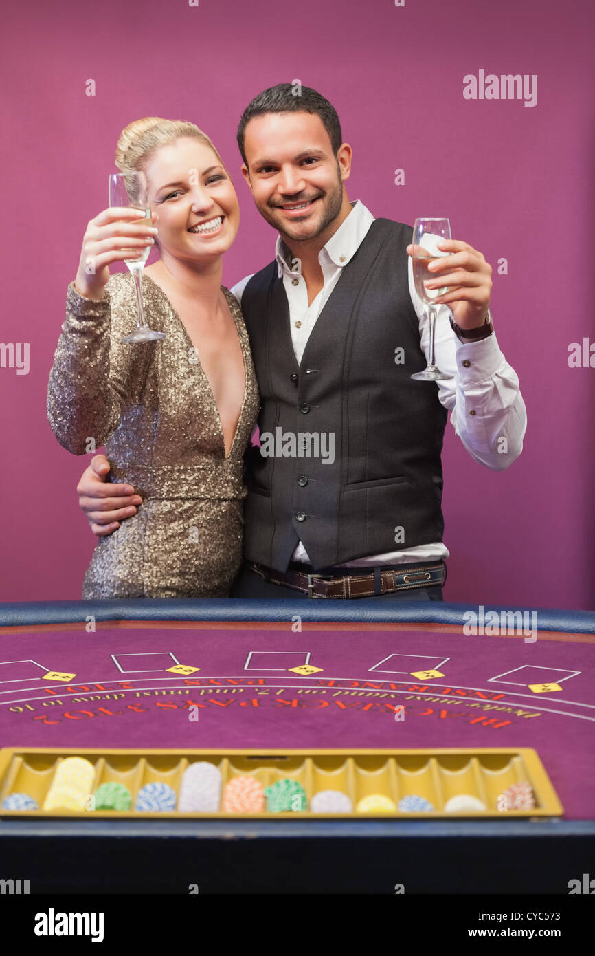 Two people toasting in a casino Stock Photo