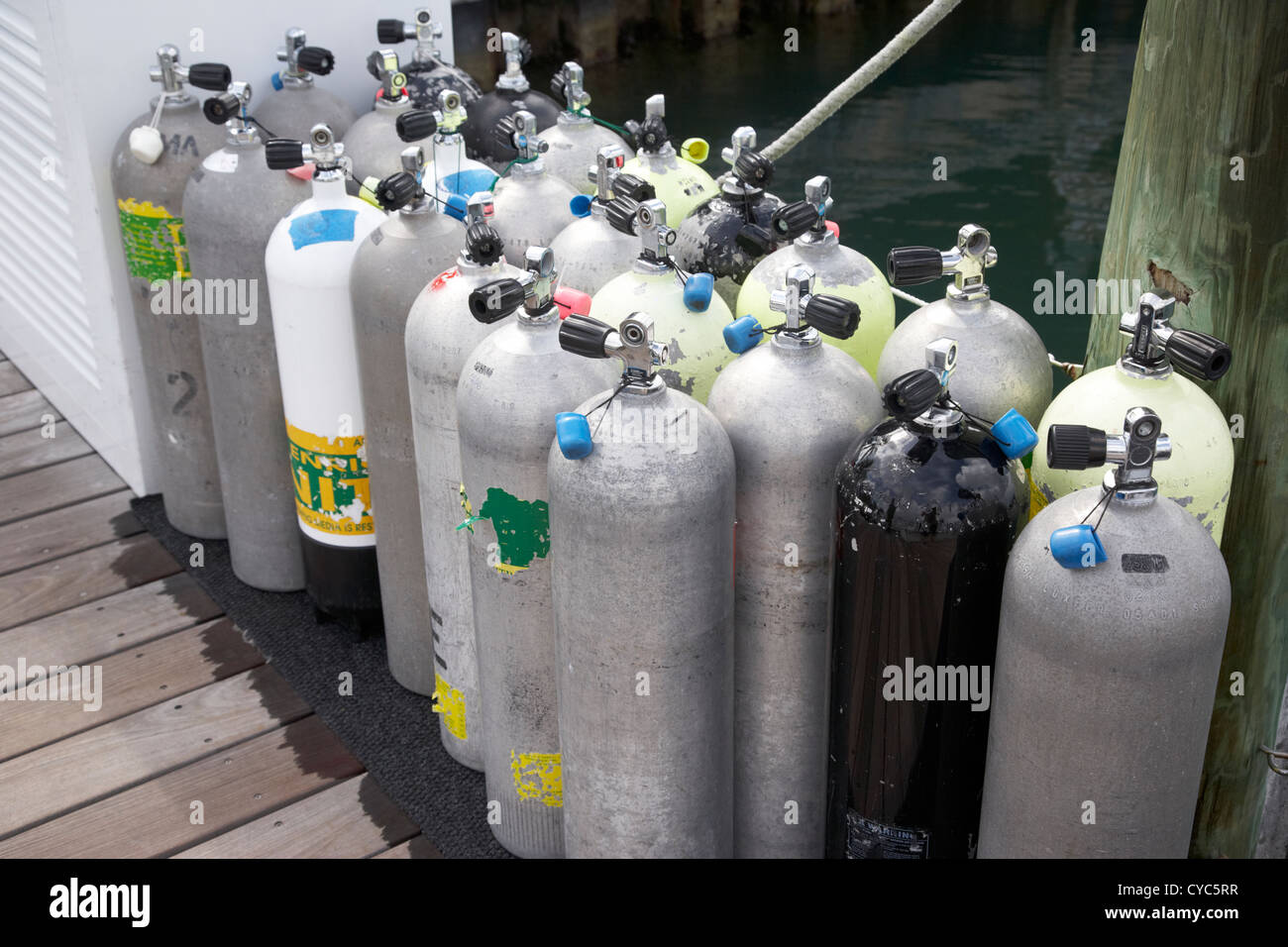 scuba air tanks lined up on jetty to be filled in harbour key west florida usa Stock Photo
