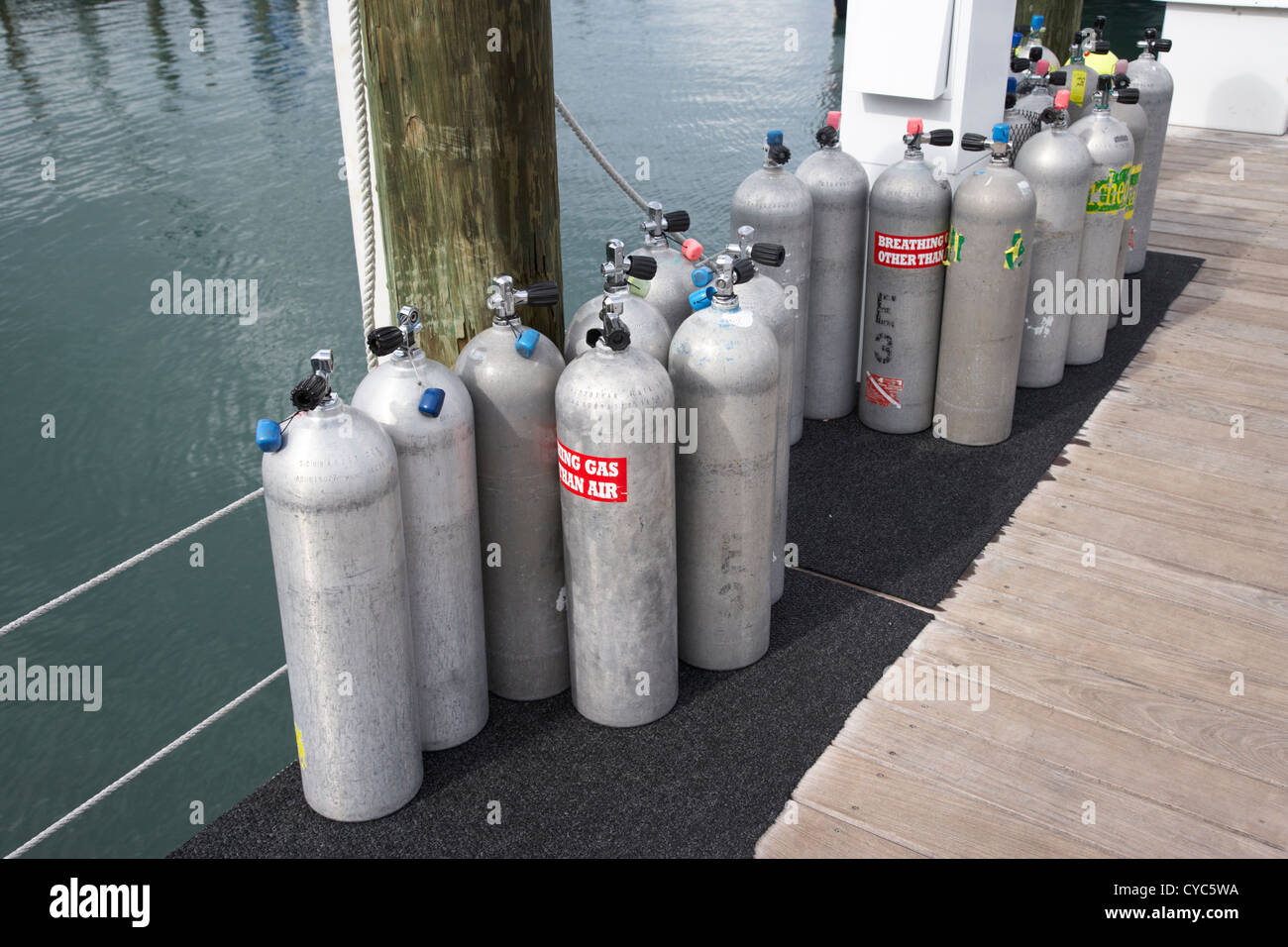 scuba air tanks lined up on jetty to be filled in harbour key west florida usa Stock Photo